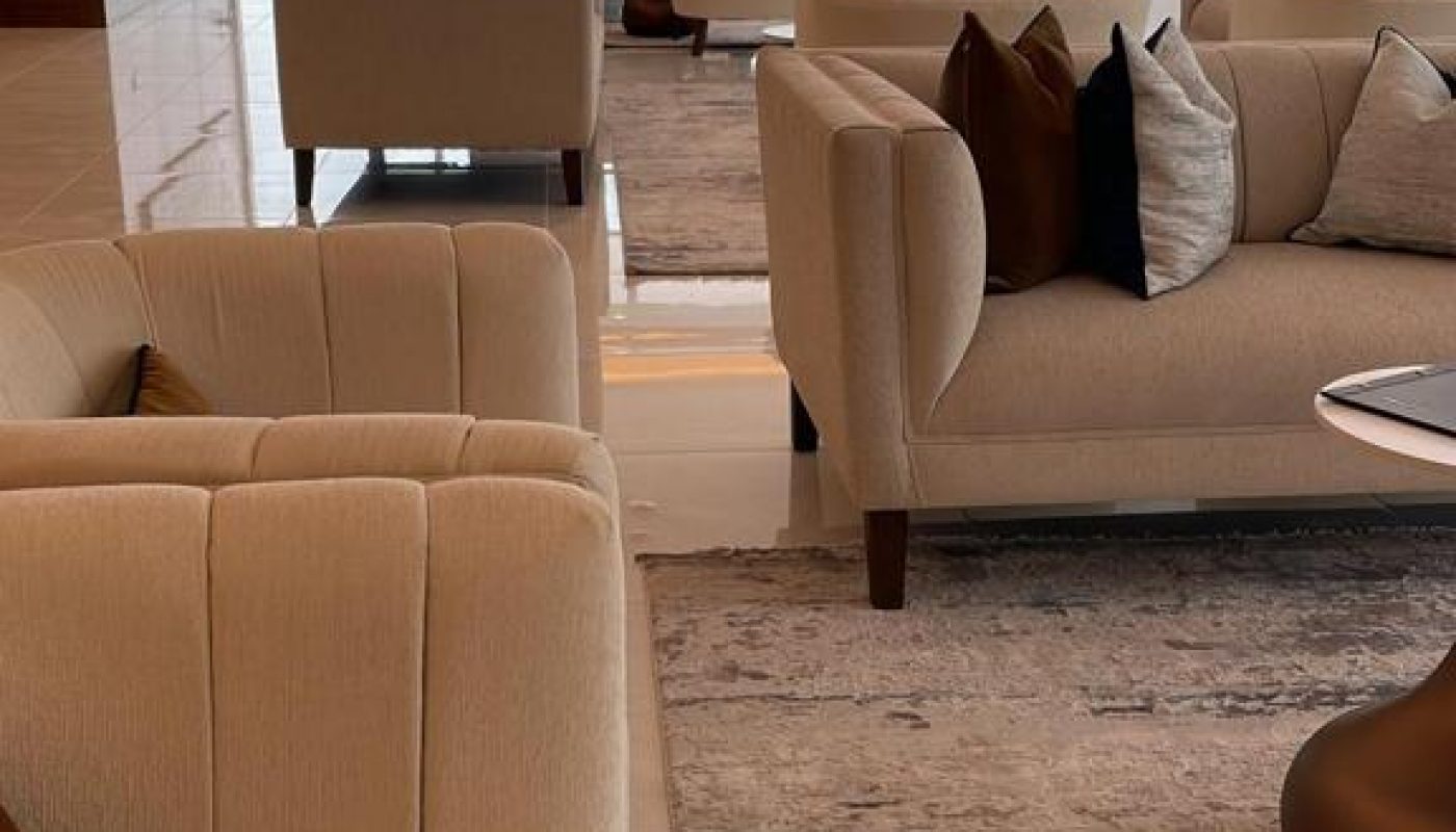 A large lobby with couches and a coffee table, offering a panoramic view.