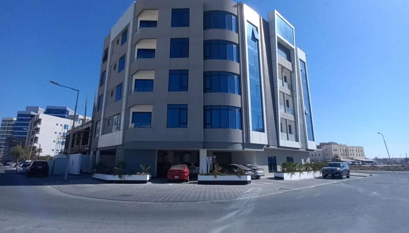 An apartment building with a car parked in front of it for sale in Seef.