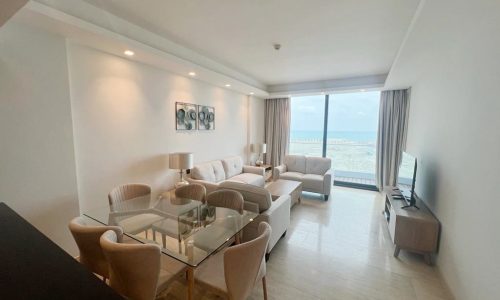 A luxury 2-bedroom living room and dining area with a view of the ocean in Delmunia.