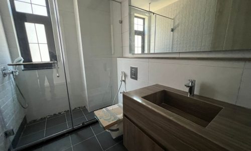 A huge bathroom in a luxury villa on Dilmunia Island, featuring a glass shower stall and sink.