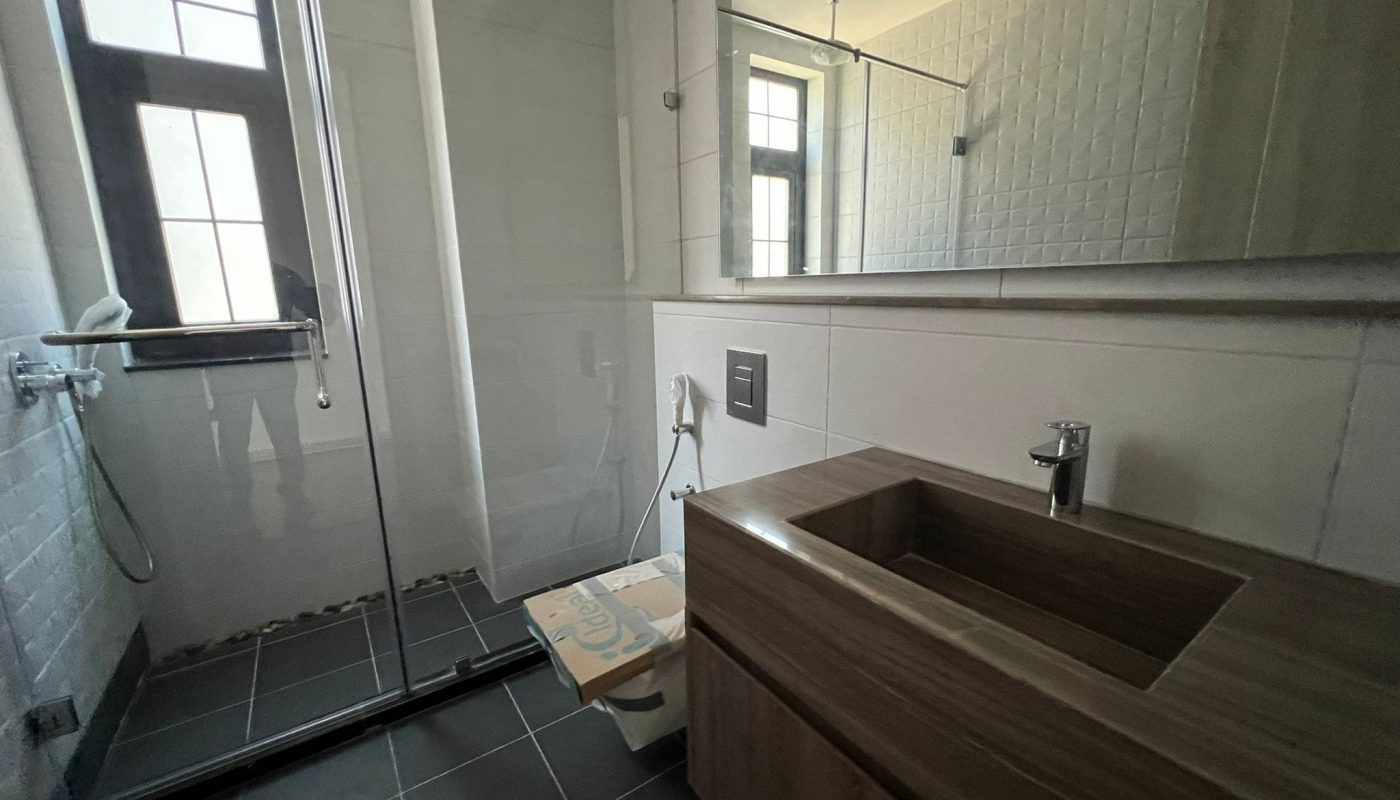 A huge bathroom in a luxury villa on Dilmunia Island, featuring a glass shower stall and sink.