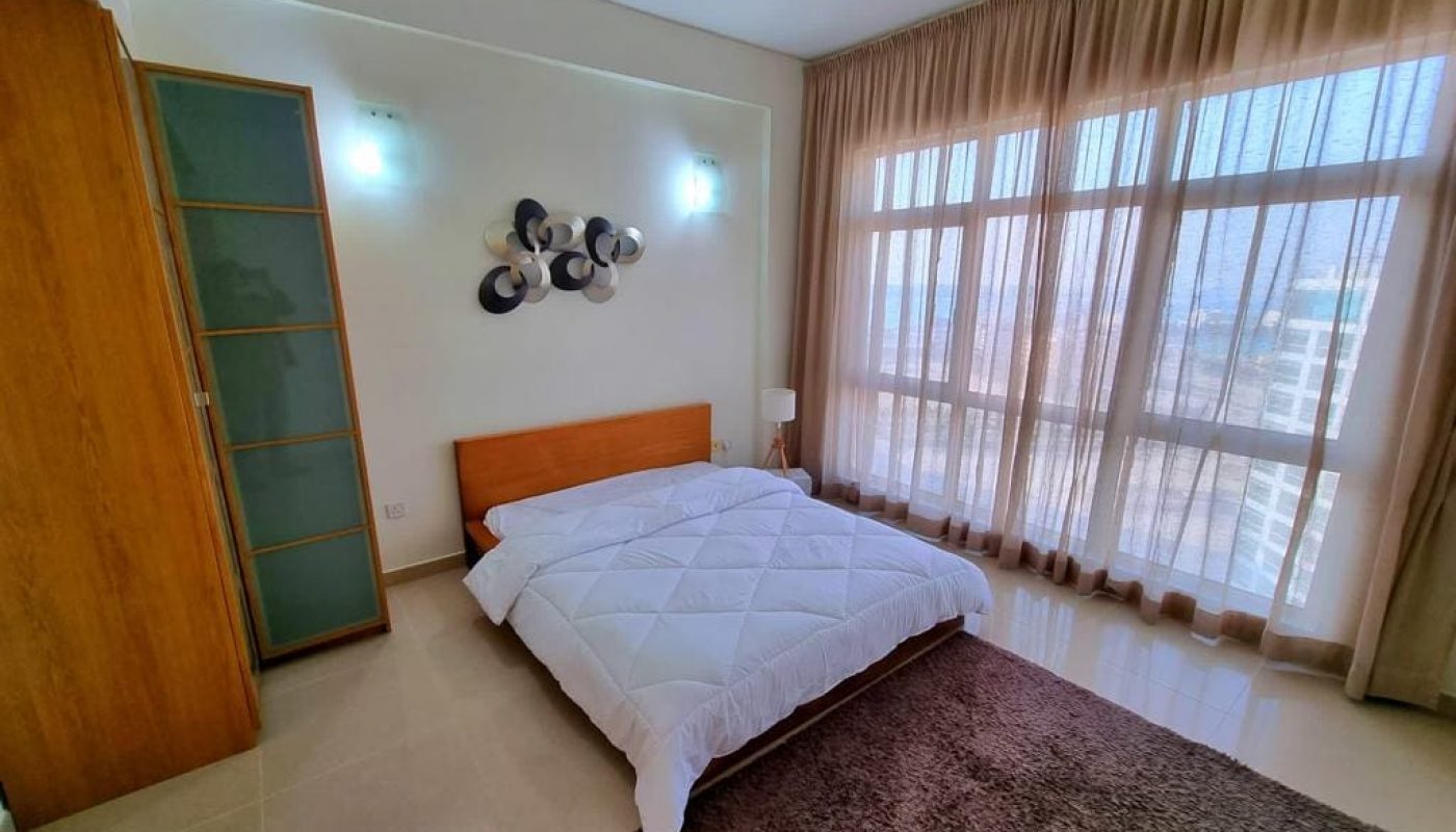 Immaculate bedroom with a large window.