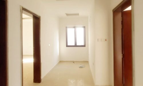 An empty room with doors and windows, ideal for a villa sale in Bani Jamra.