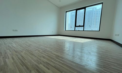 A luxury apartment with large windows and hardwood floors, available for sale.