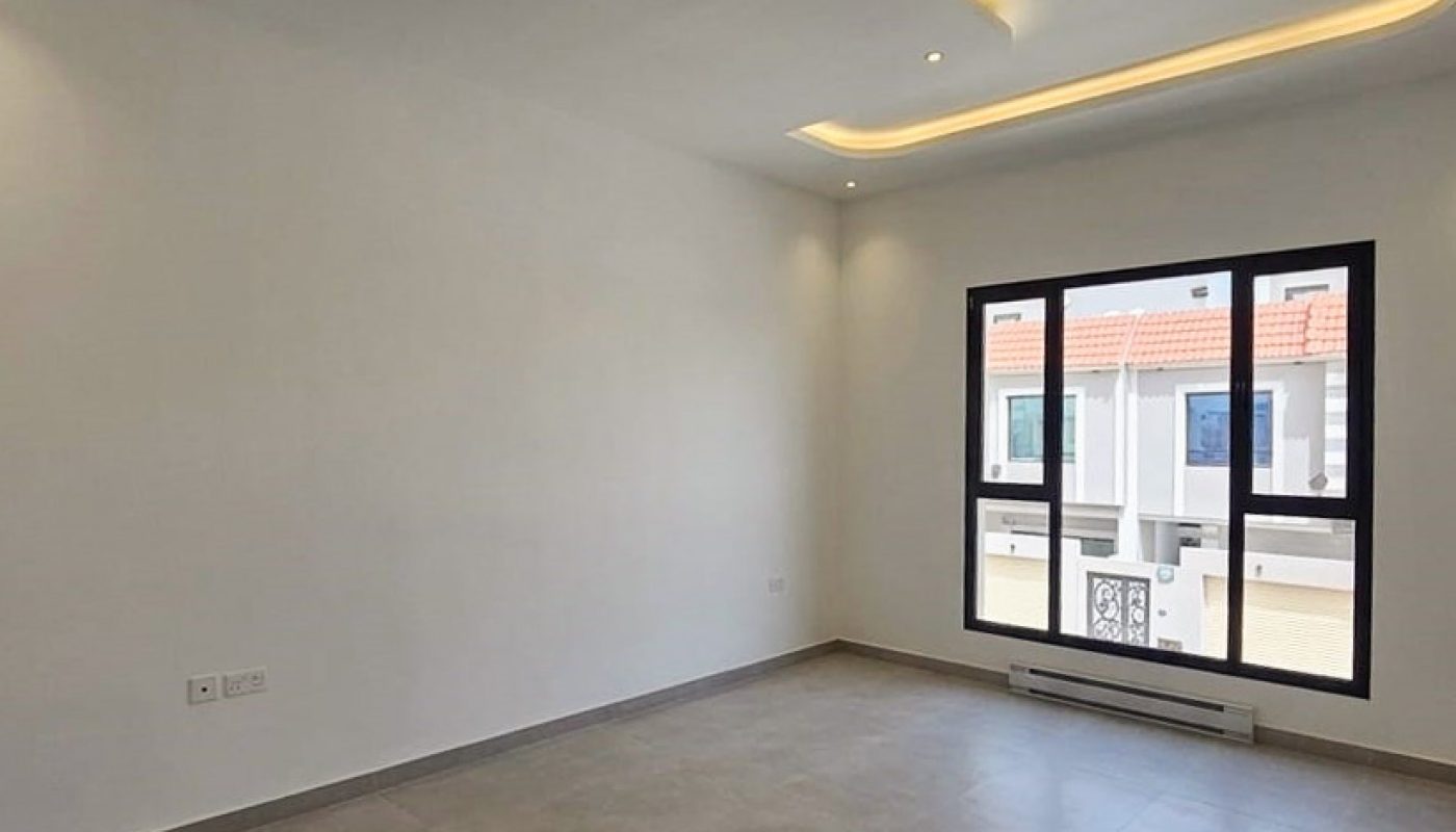 Unfurnished room with large window, gray tiled floor, white walls, and recessed ceiling with built-in lighting.
