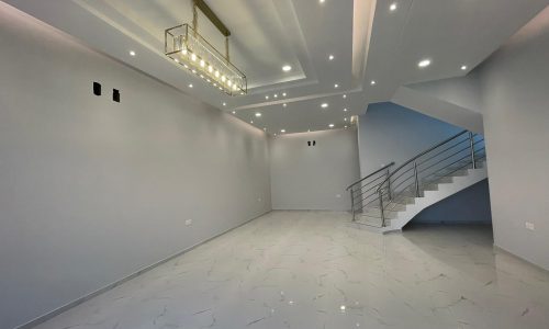 A modern room with white walls and a staircase.