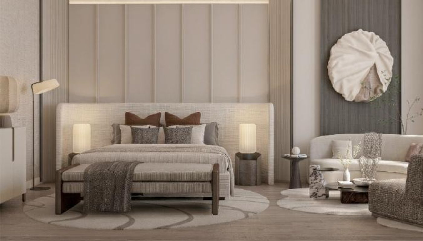 Modern bedroom with neutral tones, double bed, two bedside lamps, a sofa seating area, and minimalist decor, including a circular wall art piece and area rugs on wooden flooring.