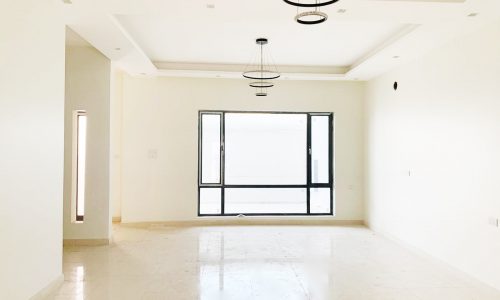 Perfect Location 4BR Villa for Sale in a large empty room with light fixtures.