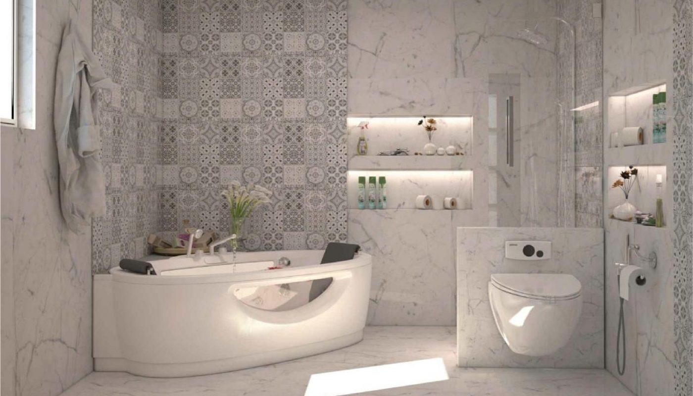 Modern bathroom with a bathtub, wall-mounted toilet, patterned tile accent wall, built-in shelves with toiletries, and marble flooring. Light enters through a window on the left.
